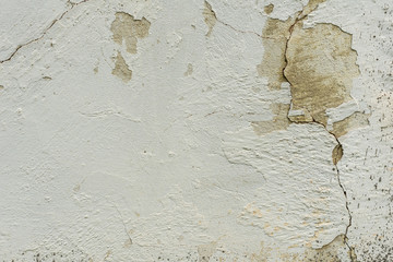Texture of a concrete wall with cracks and scratches which can be used as a background