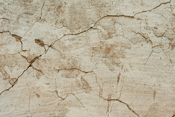 Texture of a concrete wall with cracks and scratches which can be used as a background
