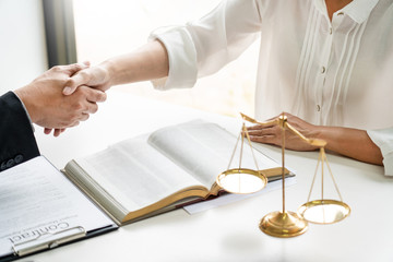 Handshake after cooperation between attorneys lawyer and clients discussing a contract agreement...
