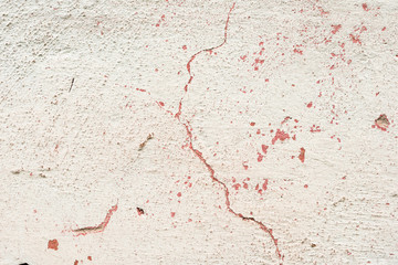 Texture of a concrete wall with cracks and scratches which can be used as a background