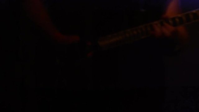 Guitarist rock band plays guitar on stage in the spotlight. Soft focus