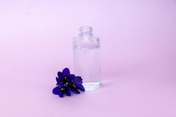 liquid in  transparent bottle with pipette for soaring electronic cigarettes with  scent and taste of flowers, on  pink background with space for text.
