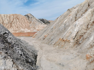 Clay Open Quarry Mars Landscape with red Water.  stone Texture. Erosion Crack Hill Desert Surface