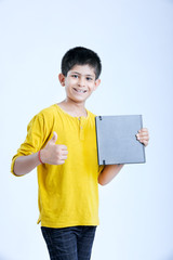 young indian boy showing notebook 