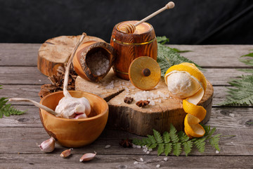Still life with lemon and honey, on a wooden background in a rustic style. The concept of treating colds. Ethnoscience.