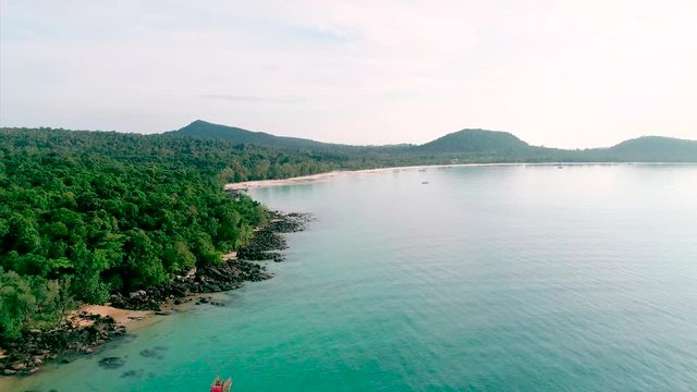 Aerial view of wild beach, jungle and long coastline. Beautiful wild beach in Asia . Forest and mountain in background. Koh Rong island, Cambodia.
