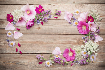 Fototapeta na wymiar summer flowers on old wooden background