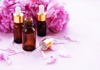 Aromatherapy essentials oils and pink peonies