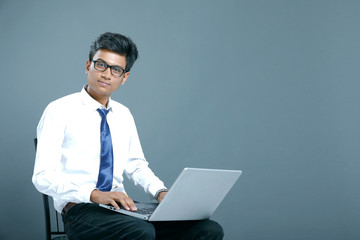 Young indian employee with laptop