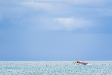 Boat on the Tyrrhenian Sea seen from the Minori and Maiori Beach, Amalfi Coast, Campania, Italy