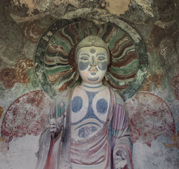 Fototapeta na wymiar Sculpture of Buddha in a niche of a grotto at Mount Maiji or Maijishan Grottoes, Tianshui, Gansu, China. Constructed from late fourth century CE. National heritage.
