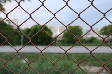Fototapeta premium fence with barbed wire and road