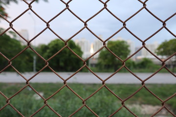 fence with barbed wire and road