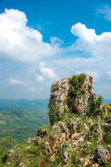 Tower of Rock or Stone with White Cloud and Blue Sky and Blur Scenic Landscape Valley Below