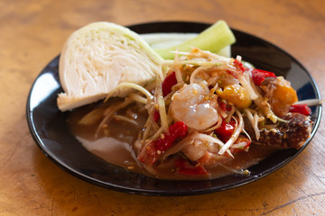 Thai's spicy Papaya salad healthy food on wood table