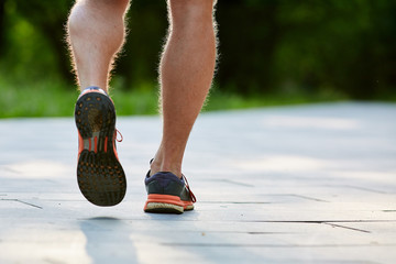 Man is jogging in the park on green background - 276653402