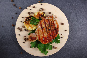 grilled steak with parsley on stone background