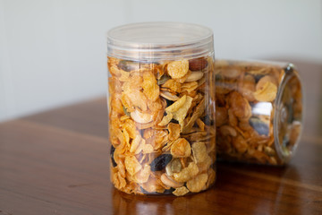 Homemade organic healthy granola with dried fruits in bottles