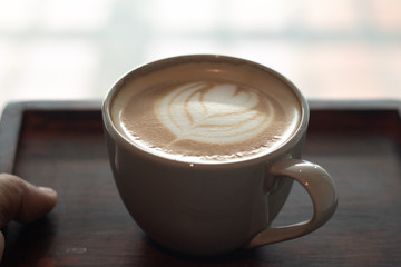  Latte art in cup on wooden desk