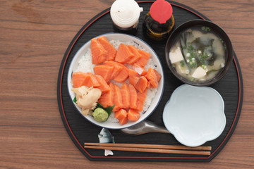 Salmon Donburi or Salmon sushi don, Japanese food on wooden desk background