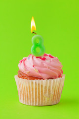 Delicious cupcakes with candles on a colored background. Festive background, birthday