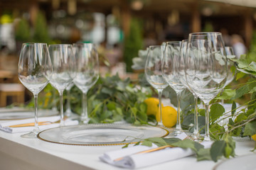Beautiful decorated wooden decor and floristics and a selection of glasses for different sorts of wine for a tasting or wedding party