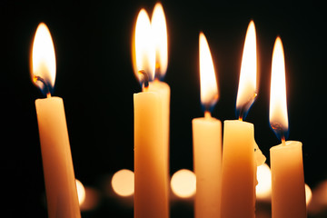 the light of the candle illuminates the darkness