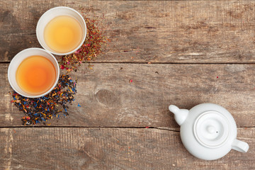 Collection of different teas in cups with tea leaves
