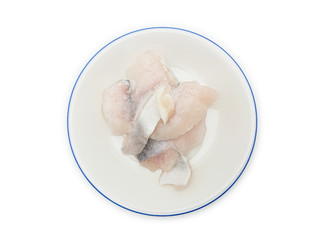 Slice frozen fish on the round plate isolated on white background
