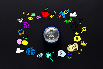 Tin can with a drink on a black background with icons. minimalism. Concept of day and night, caffeine, energy drink, fun, holiday. Flat lay, top view