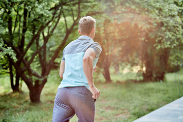 Man is jogging in the park on green background - 276655480