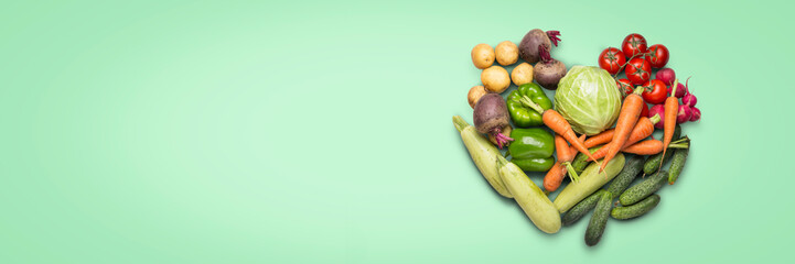Fresh organic vegetables on a green background. Concept of buying farm vegetables, care of health,...