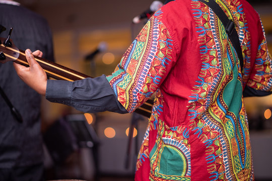 Guitarist with african print performing live