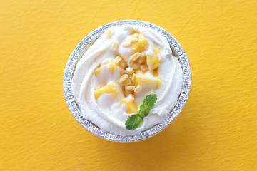 Summer fruit dessert is Mango cheesecake on yellow table background