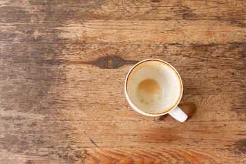 Closeup of Empty white coffee's cup after drink on wooden table