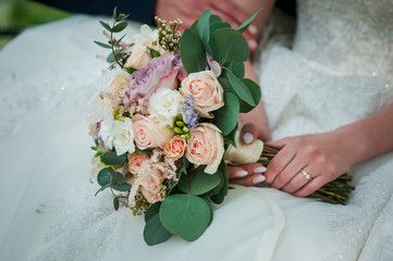 Bouquet of flowers in the hand of the bride