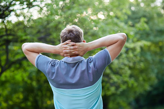 Man in the forest against green tree background