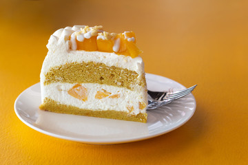 Summer fruit dessert is Mango cheesecake on yellow table background