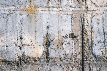 Concrete wall with rusty metal fittings. Can be used as a texture, background or wallpaper