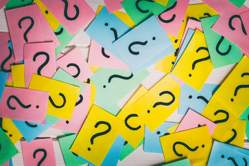 colorful paper notes with question marks. Closeup