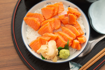 Salmon Donburi or Salmon sushi don, Japanese food on wooden desk background