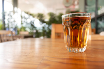 A cup of hot tea on wooden desk