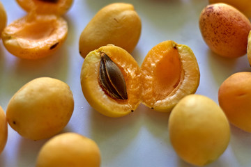 orange apricots lie on a white table