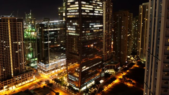 Timelapse view of city traffic flow near ICBC tower , Bank of China tower in central Manila, Philippines.view of city skyline.