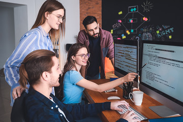 Team of programmers working in office