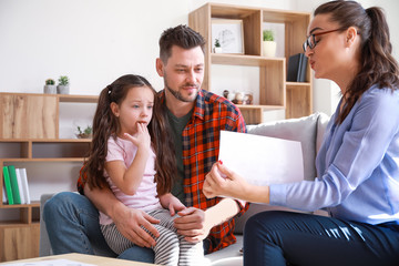 Female psychologist working with family in office