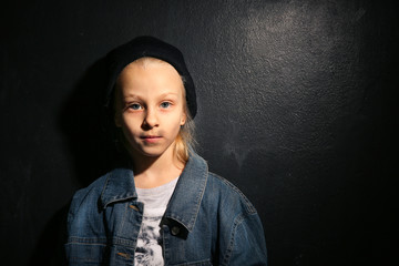 Homeless little girl on dark background