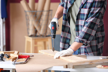 Male carpenter working in shop