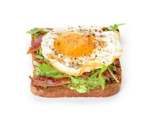 Tasty toast with bacon and fried egg on white background