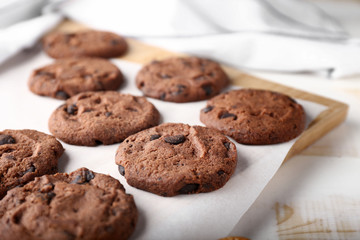 Tasty chocolate cookies on light table